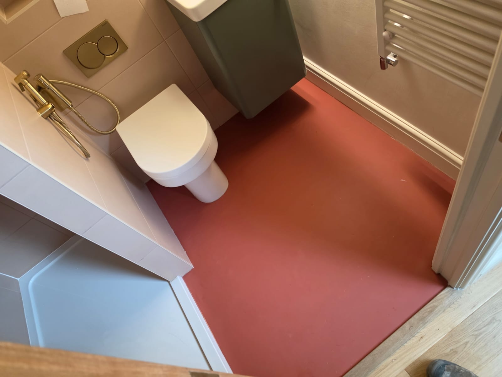 Bold red sheet rubber flooring in an en-suite bathroom, Chorlton
